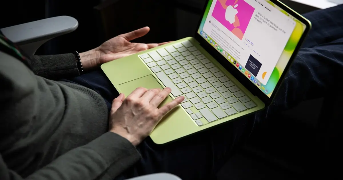 MacBook Neo da Apple ao lado de laptops da Asus e Dell. Alt Text: "MacBook Neo da Apple desafia fabricantes de PC