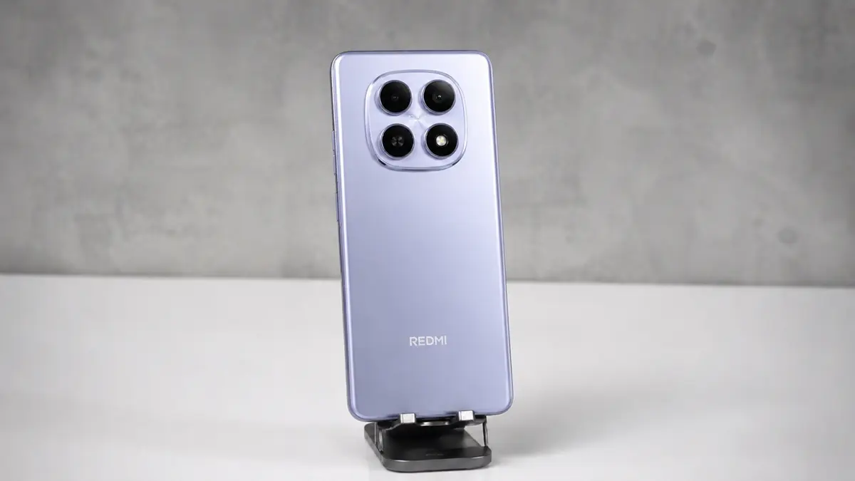 Redmi Note 15 5G é bom? A verdade nua e crua 3 Redmi note 15 5g cor lilas em um suporte sobe uma mesa branca e fundo cinza